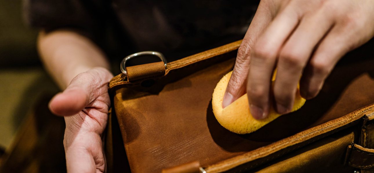 An artisan handcrafting a Moroccan leather bag, showcasing the beauty of 'moroccan handmade goods.'