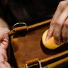 An artisan handcrafting a Moroccan leather bag, showcasing the beauty of 'moroccan handmade goods.'