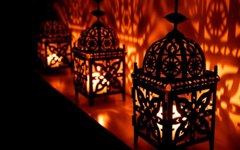 Handcrafted Moroccan brass lanterns adding a warm glow to an outdoor space