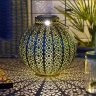 Moroccan Brass Lantern Casting Warm Glow in Outdoor Garden