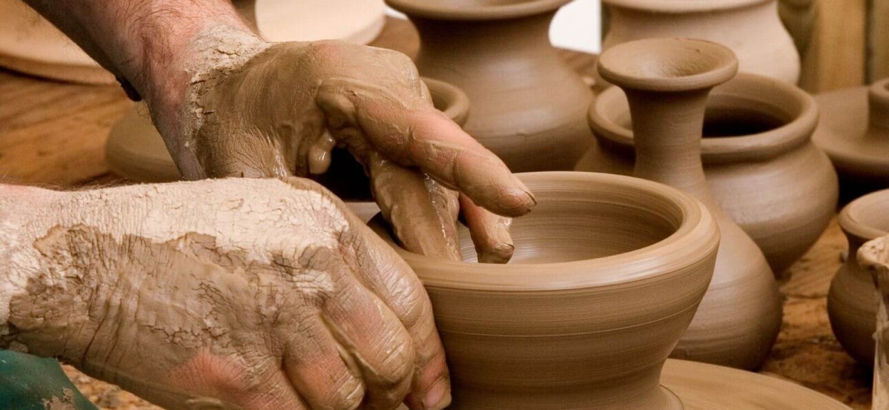 an artisan making pottery