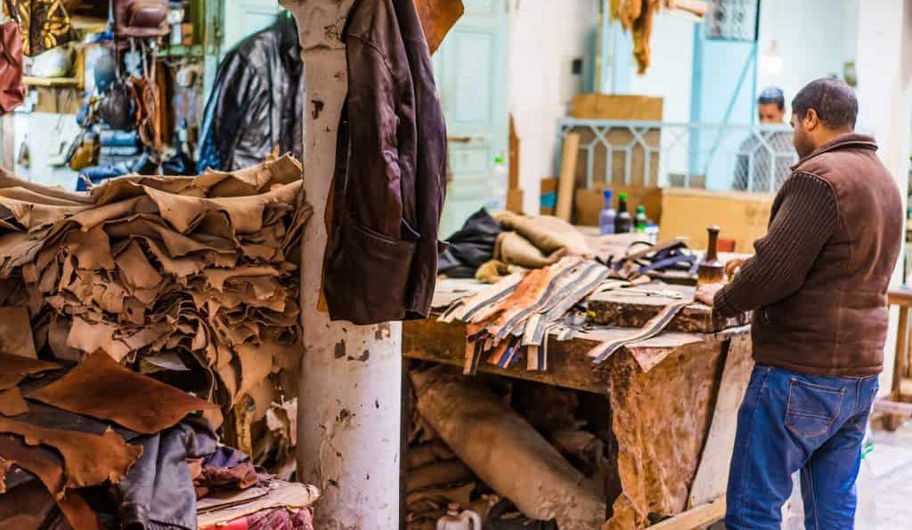 Artisan crafting a Moroccan leather masterpiece