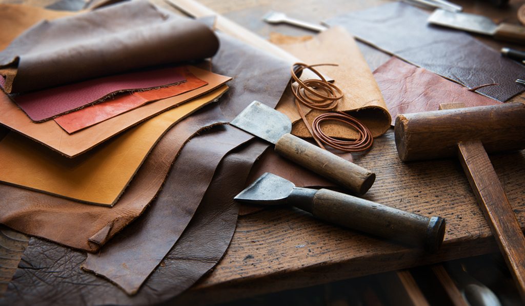 Moroccan leather artisan crafting a wallet - showcasing the artistry of handmade leather goods