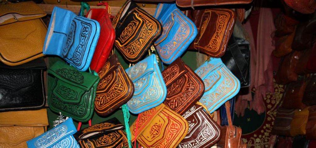 Traditional Moroccan Leather Artisan Crafting a Pouff