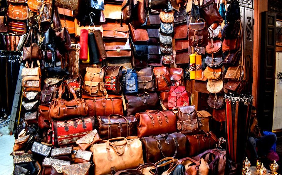 Handcrafted Moroccan leather goods showcased in a variety of colors and designs.