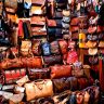 Handcrafted Moroccan leather goods showcased in a variety of colors and designs.