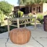 Moroccan handmade pouffs displayed in a lush garden setting